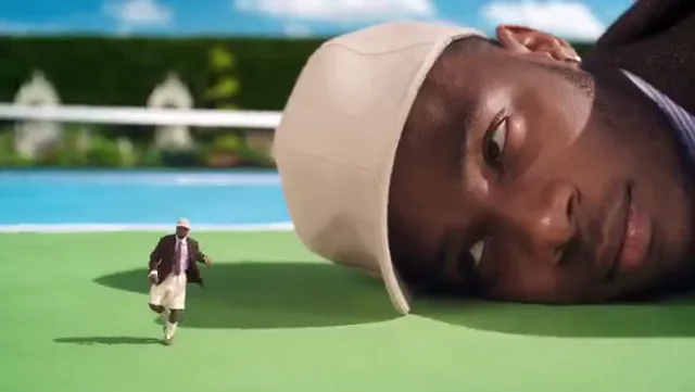 Lacewalker visual effects preview: A miniature figure moves across a green field beside an oversized person.