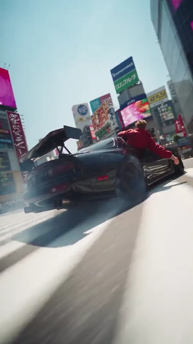 Wild ride visual effects preview: A sweeping camera follows a subject and a drifting car through a city street.